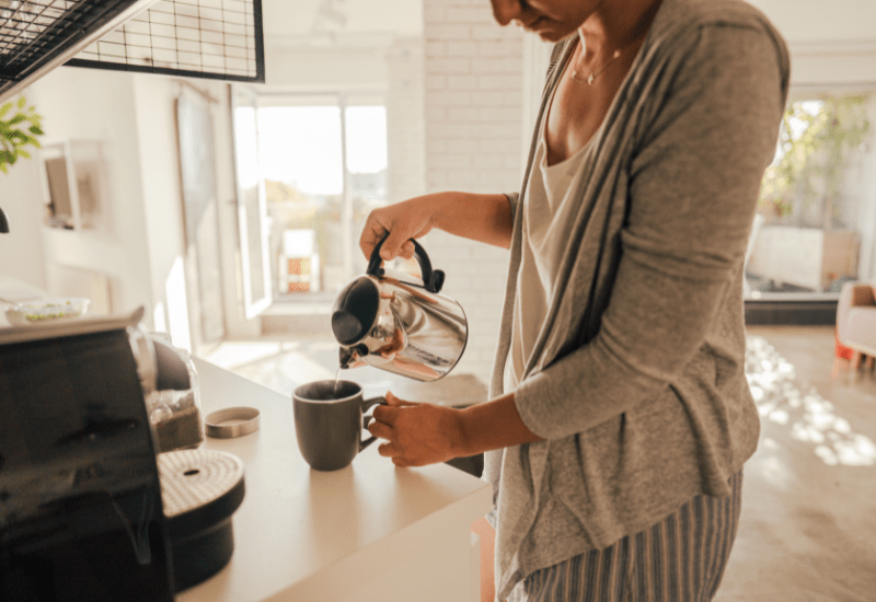 Person making coffee as part of a small daily routine that supports great success